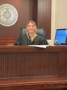 Madelyn Jordan sitting behind the judge bench