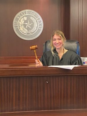 Madelyn, high school intern, holding a gavel