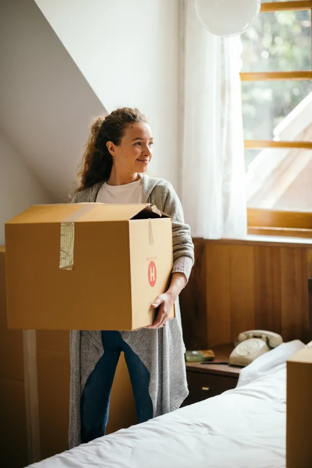 young woman holding a moving box